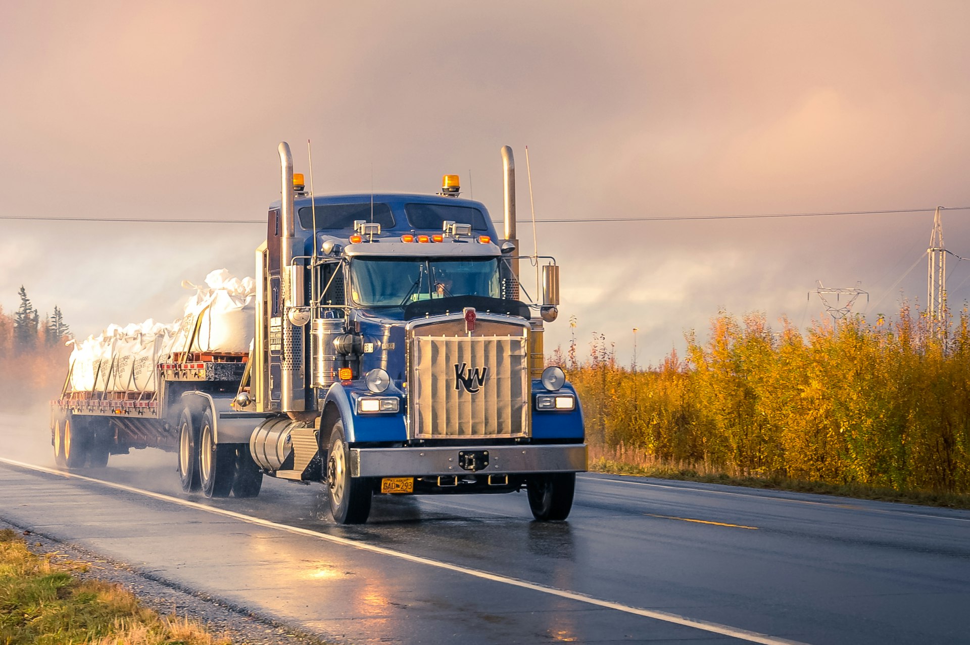 Truck driving at sunrise, symbolizing fleets that stay on the road with proactive compliance
